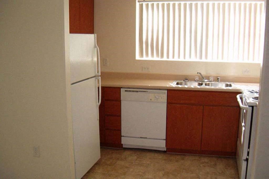 Apartment kitchen with refrigerator, dishwasher, and stove