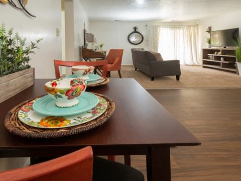 a dining room and living room with a table and chairs