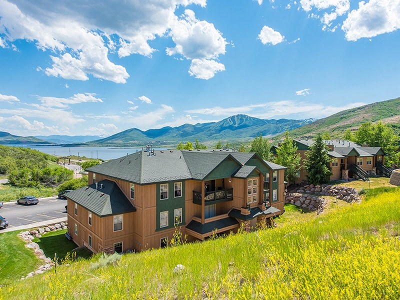 a house in a field with pink dots above it