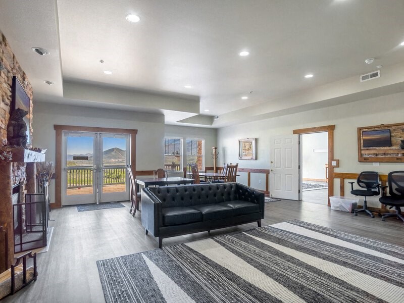 a large living room with a couch and a dining room table