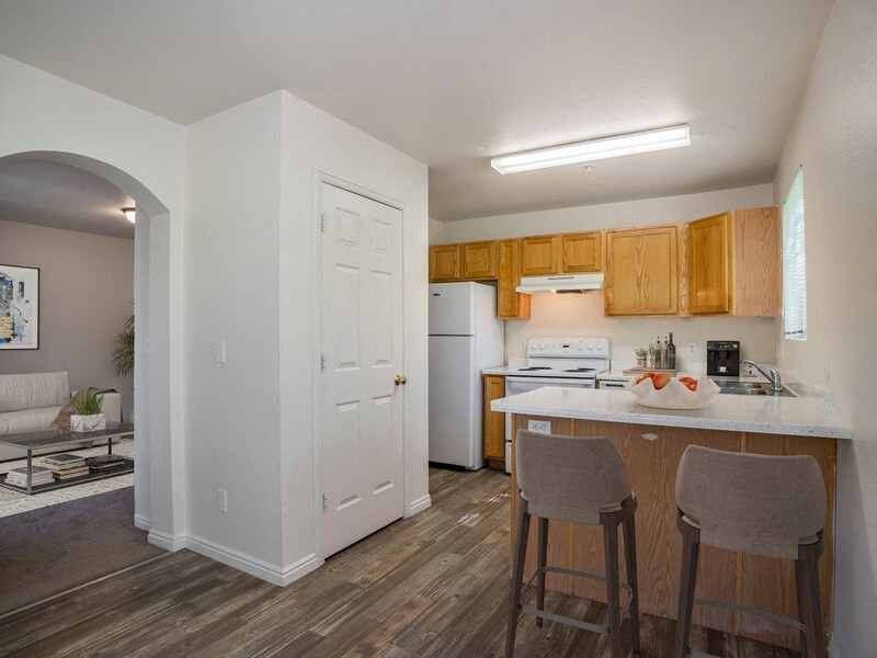 a kitchen with an island and two stools