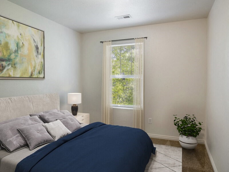 a bedroom with a large bed and a window