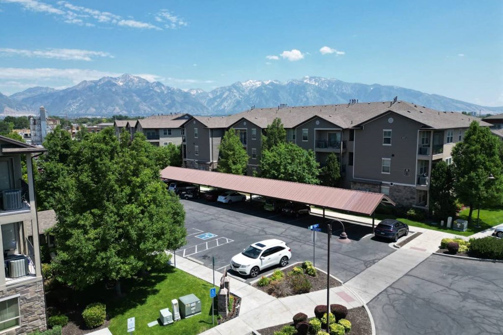 an aerial view of an apartment complex with mountains in the background
