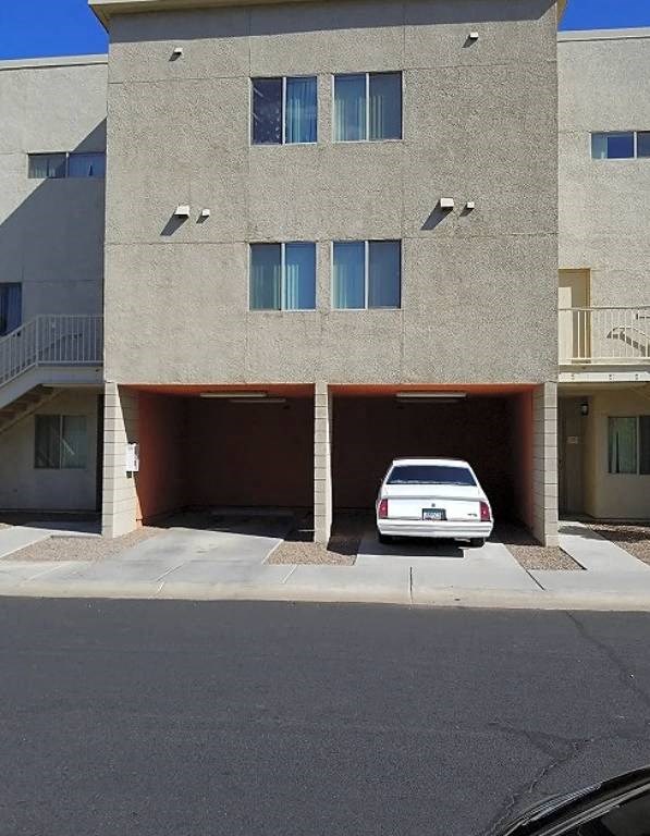 a white car parked in front of a building