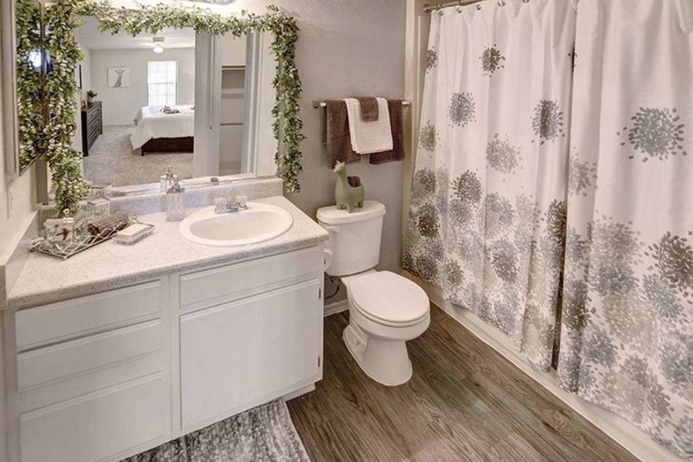 a bathroom with a shower curtain and a toilet and a sink