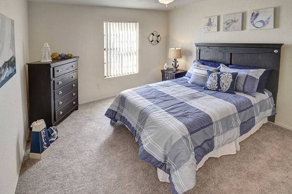 a bedroom with a bed and a dresser