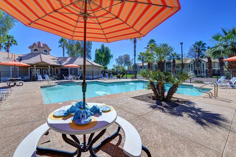 our apartments have a pool and a table with an umbrella