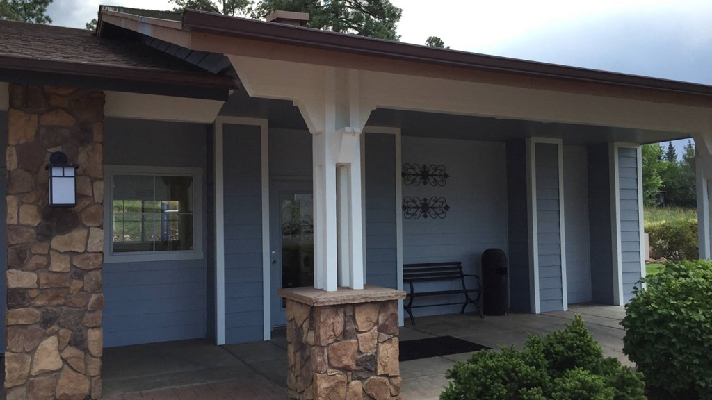 a covered porch in front of a blue house