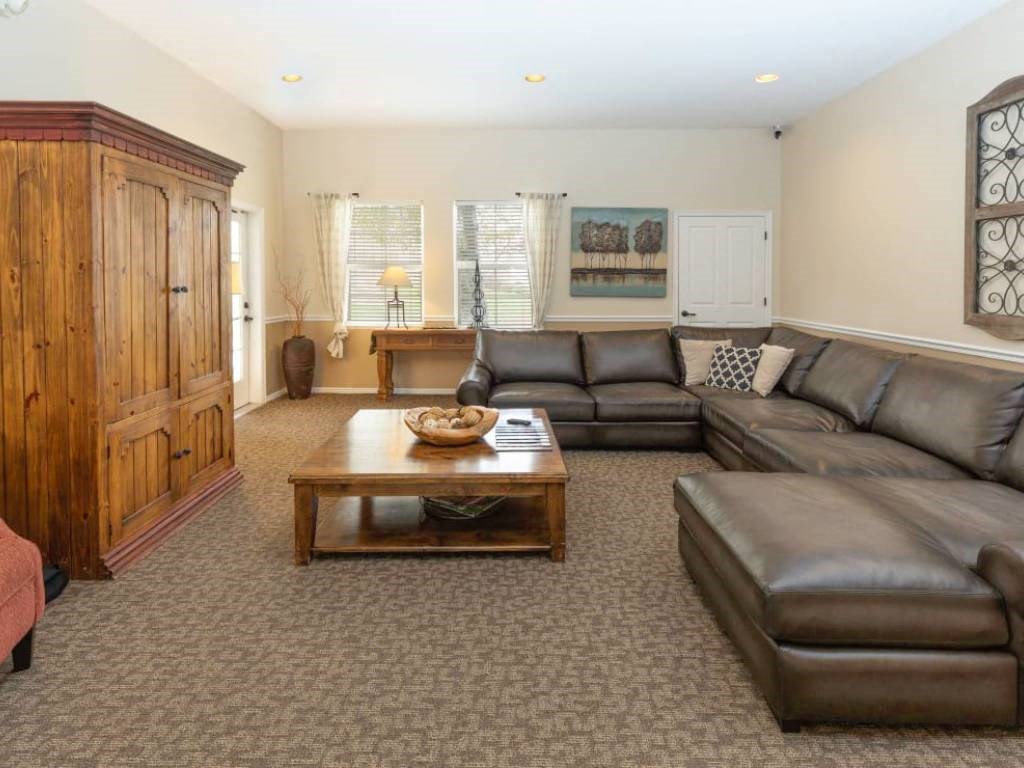 a living room with leather couches and a coffee table