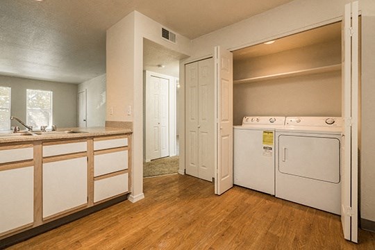 a kitchen with a washer and dryer and a sink and a laundry room