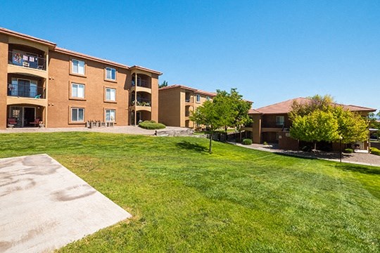 a large lawn in front of an apartment building