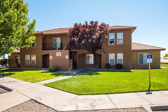 a brown house with a lawn in front of it