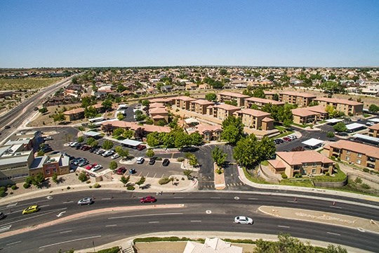 an aerial view of an intersection with cars and buildings