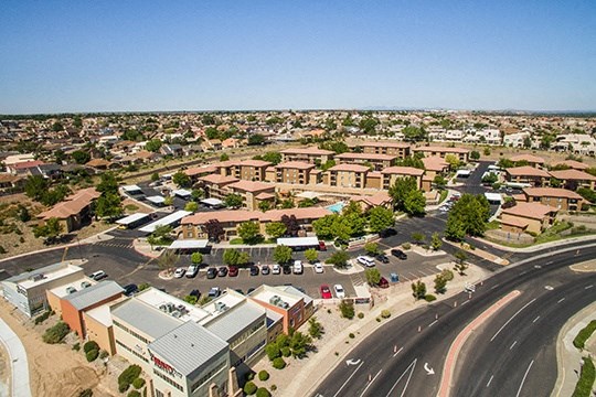 an aerial view of a city with a highway and buildings