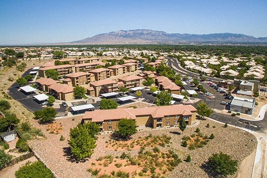 an aerial view of a city with houses and a road
