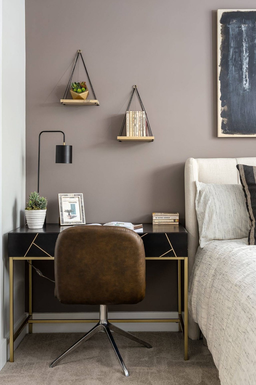a desk with a chair in a room with a bed