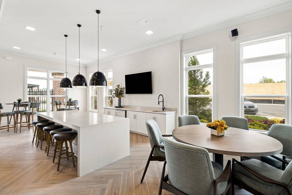 a kitchen and dining room with a table and chairs