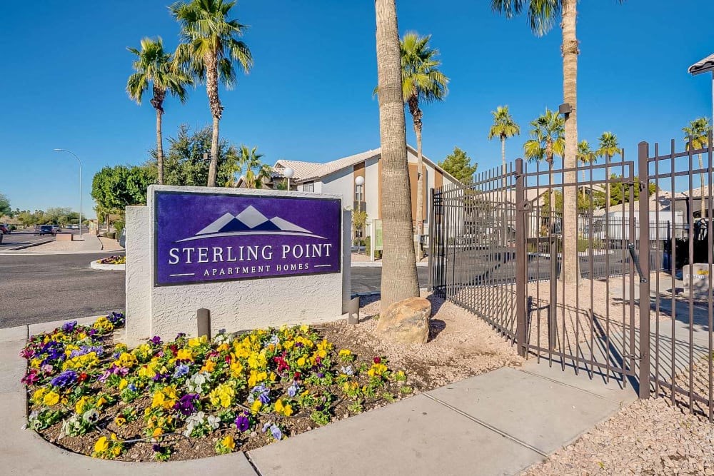 the entrance to sterling point apartments with a gate and sign