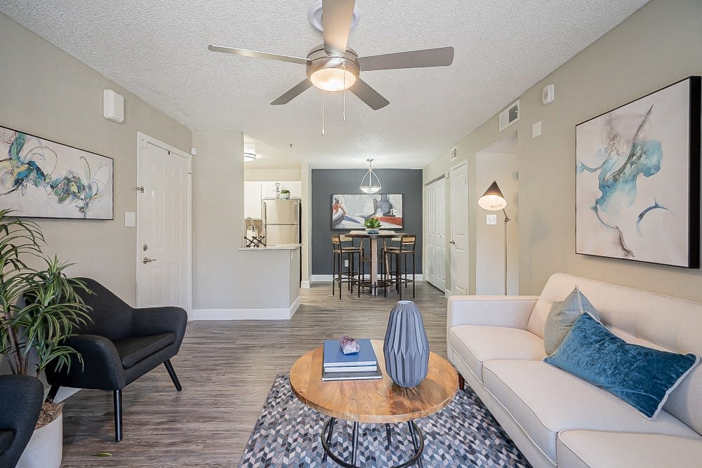 a living room with a couch and a ceiling fan
