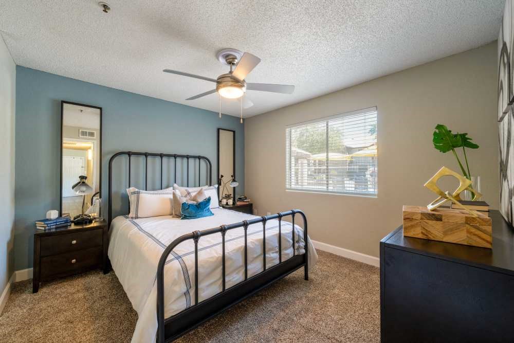 a bedroom with a bed and a ceiling fan