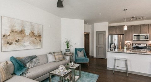 a living room and kitchen with a couch and a table