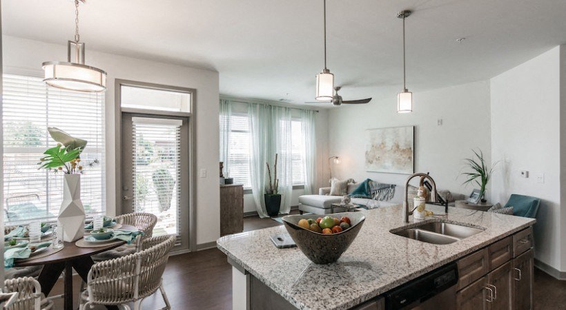 a kitchen and living room of an apartment