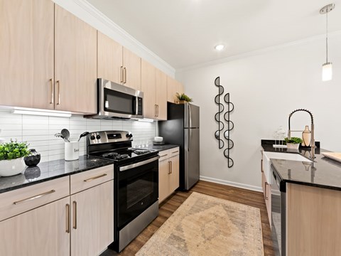A kitchen with a black stove top oven and a black refrigerator.