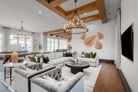 A modern living room with a grey sofa set and a wooden ceiling.