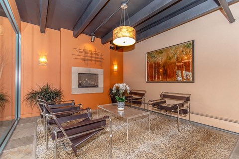 A living room with a glass table and chairs.