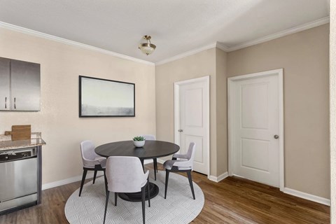A dining room with a table and chairs.