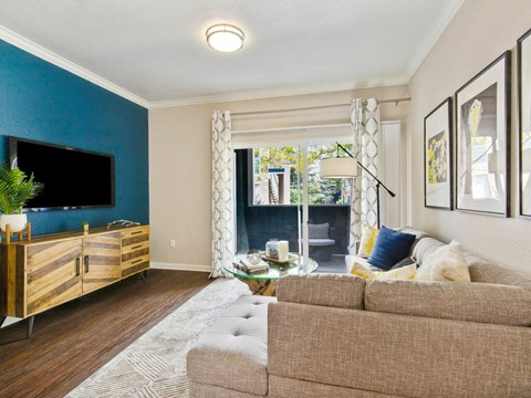 A living room with a brown couch and a wooden cabinet.