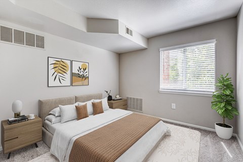 A bedroom with a large bed and a potted plant.