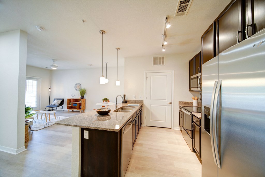 apartment kitchen with granite countertops and stainless steel applicances