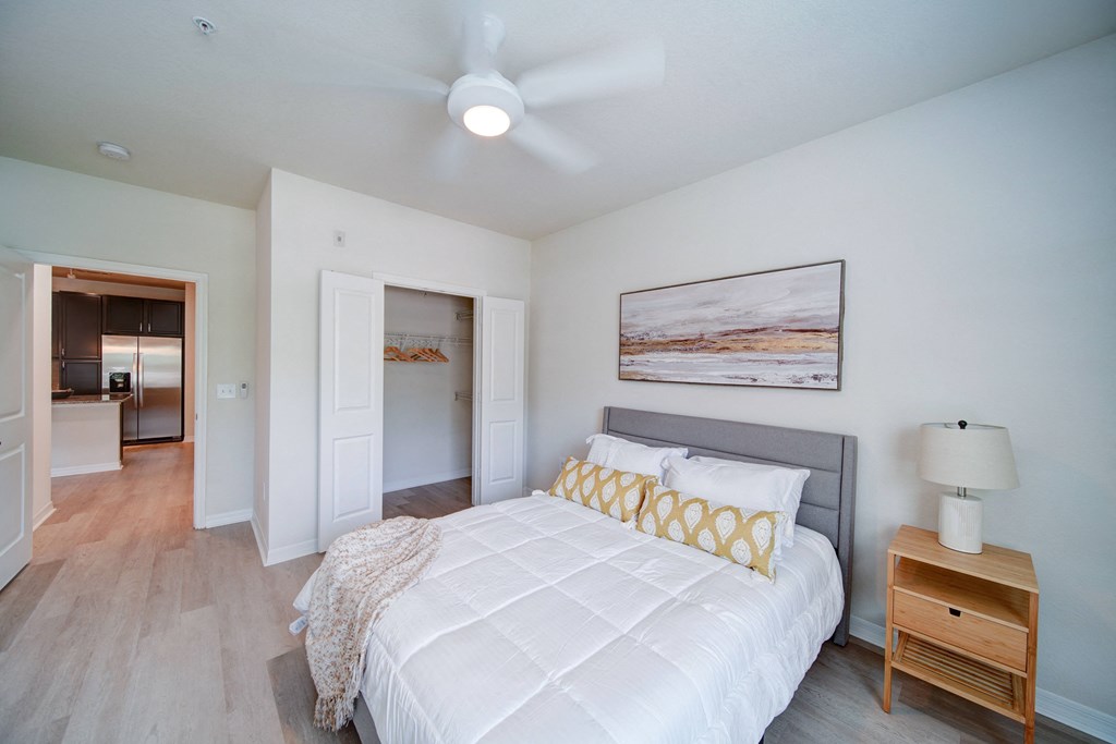 bedroom with dressed bed and night stand