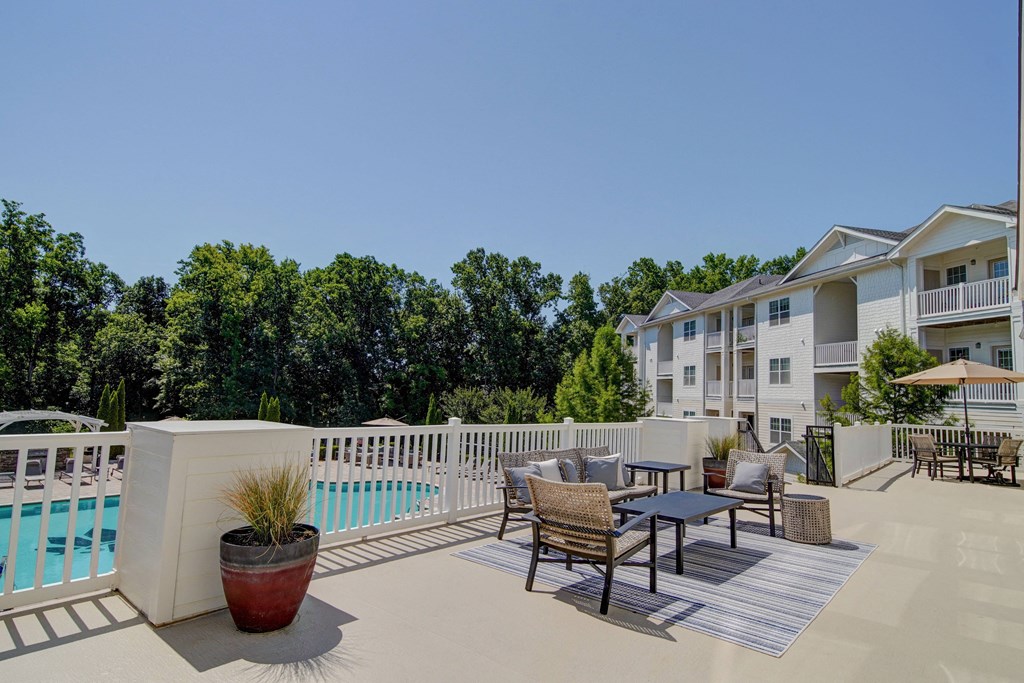 Clubhouse balcony with lounge furniture overlooking pool