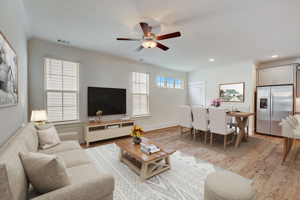 a living room with a couch and a ceiling fan