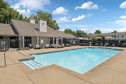 A large swimming pool with a slide in the middle of it.