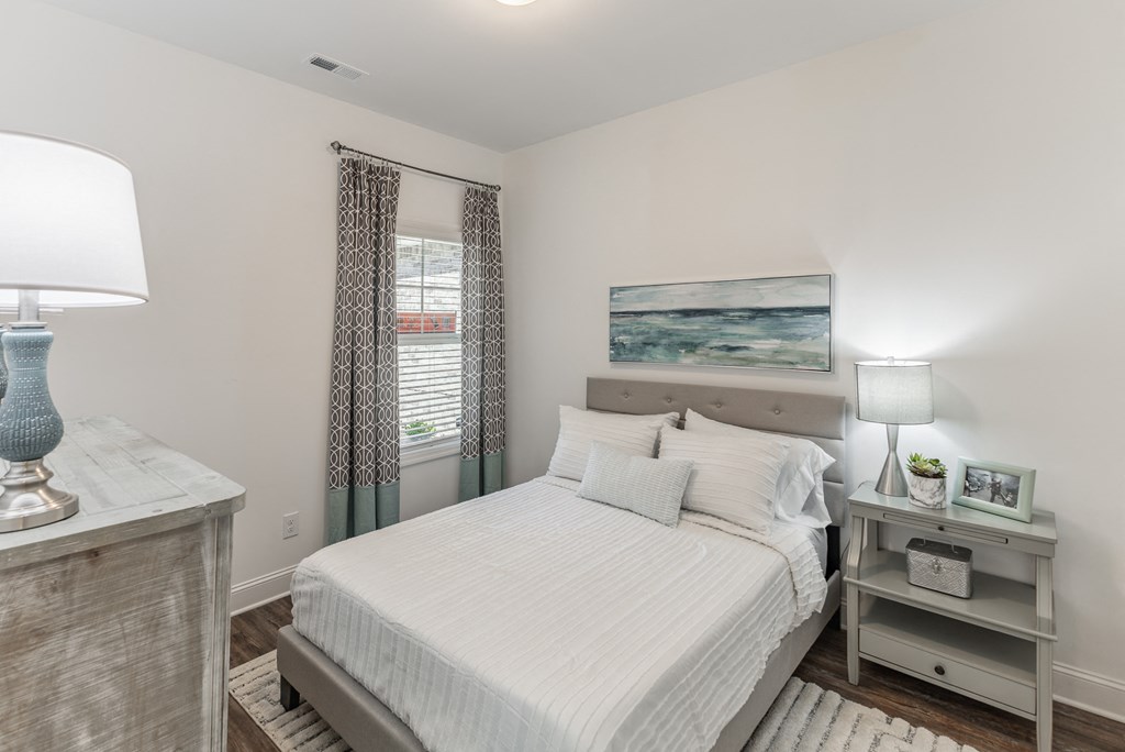 a bedroom with a bed and two windows