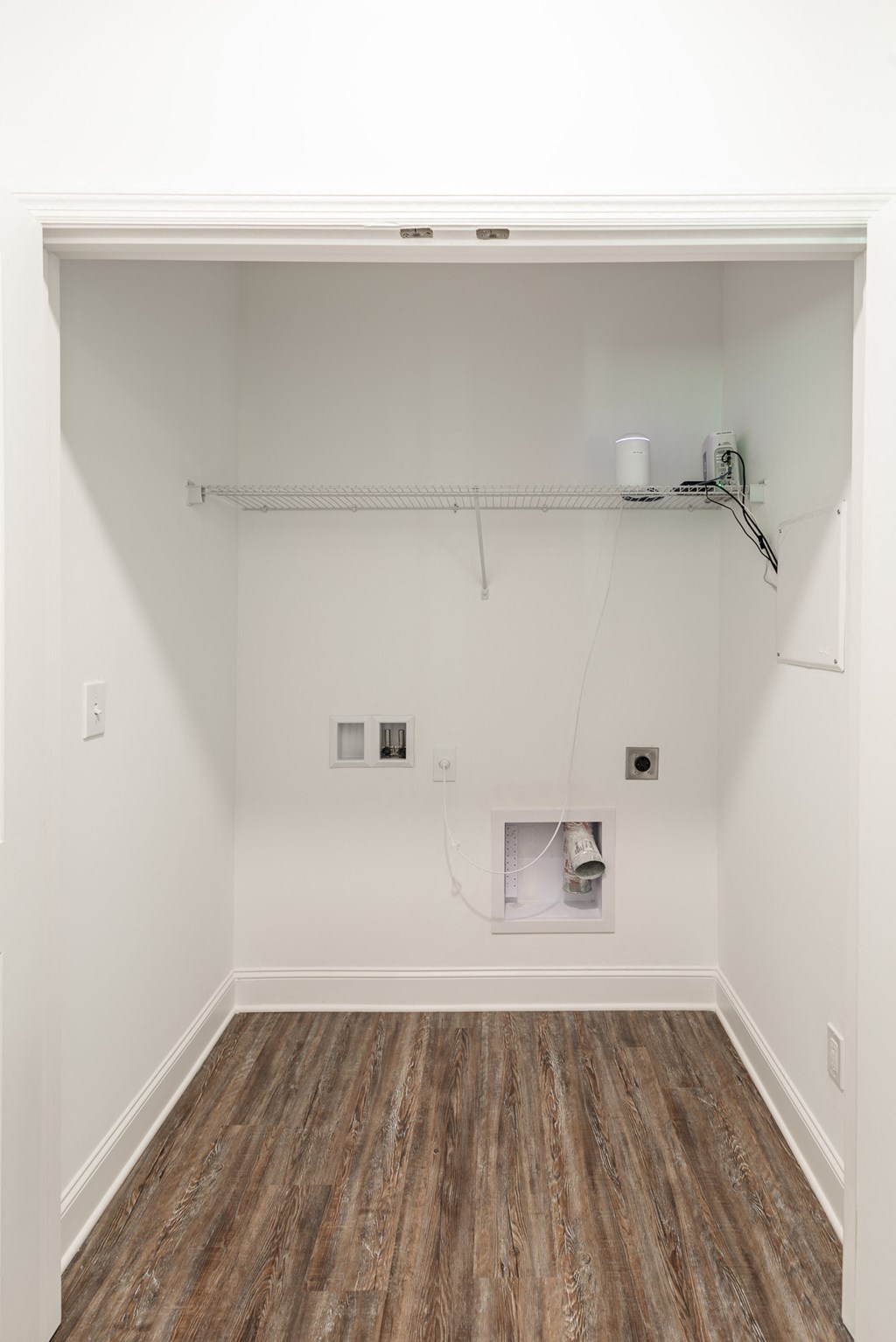 a room with white walls and a wooden floor