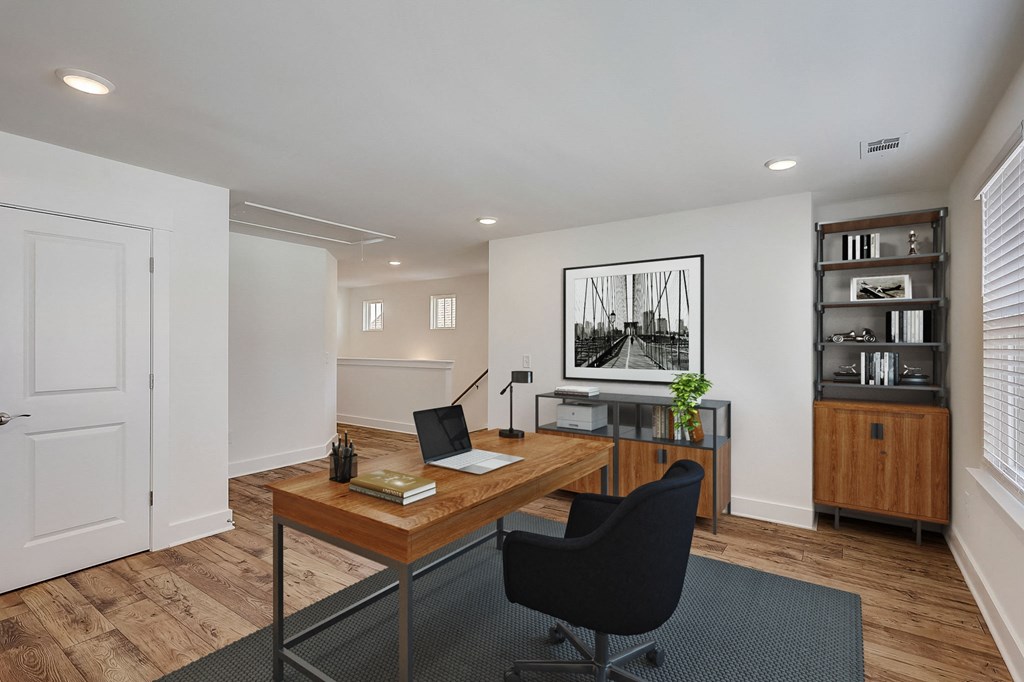 an office space with a desk and a chair and a computer