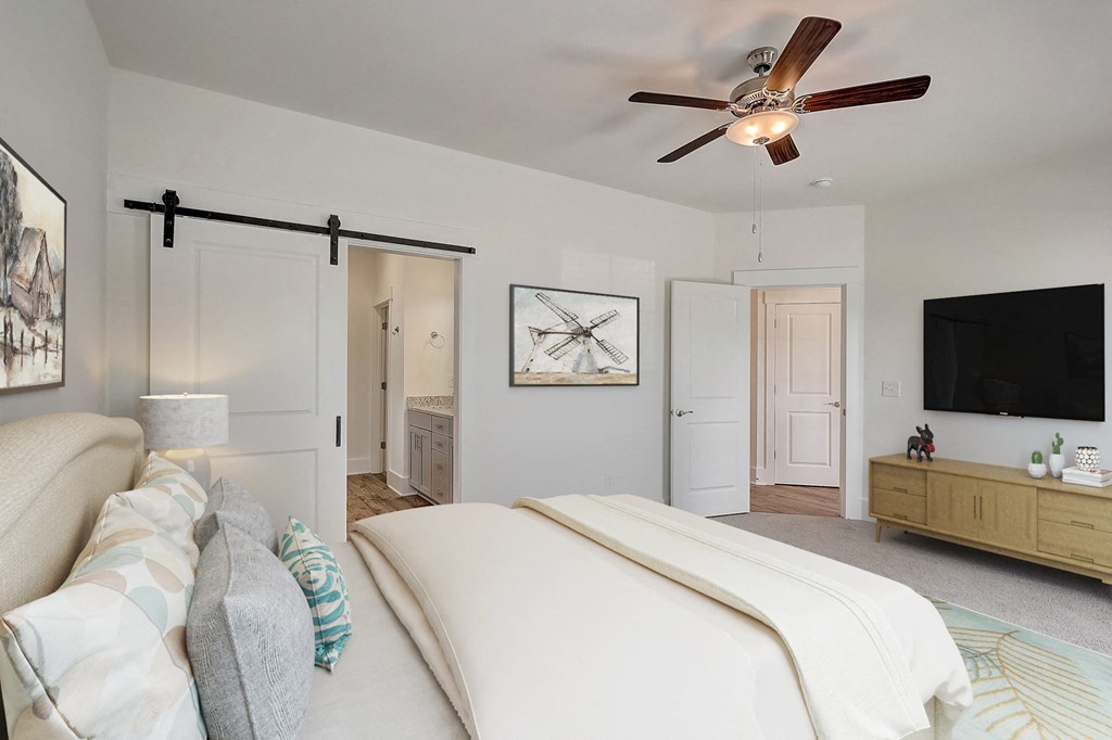 a bedroom with a bed and a ceiling fan