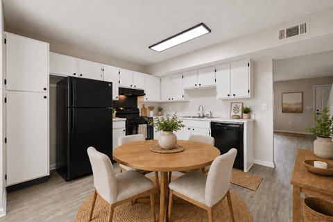A modern kitchen with a table set for two.