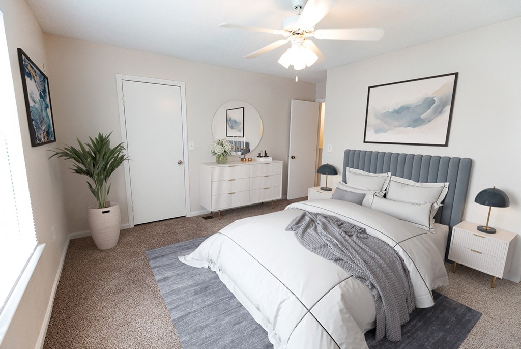 a white bedroom with a bed and a white dresser