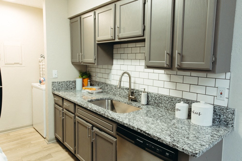 a kitchen with granite counter top and stainless steel appliances