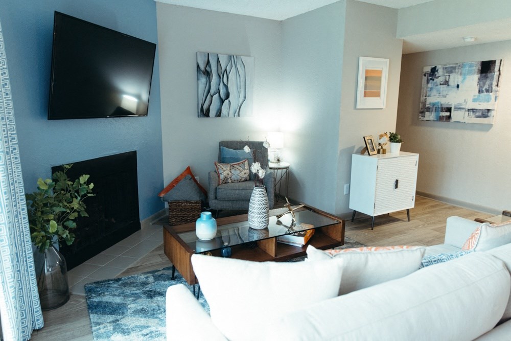 a living room with a white couch and a television