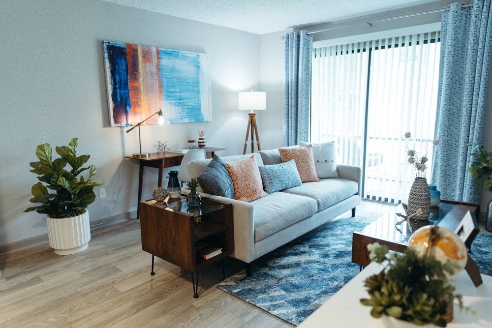 a living room with a couch and a table and a window