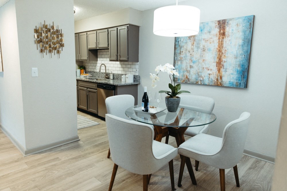 a dining room with a table and chairs and a kitchen