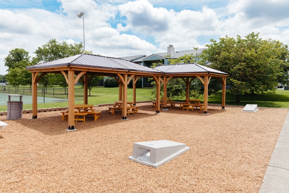 a picnic area with benches and a gazebo
