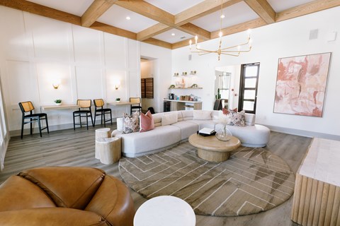 A living room with a brown leather chair and a white coffee table.