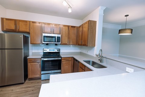 A kitchen with wooden cabinets and stainless steel appliances.